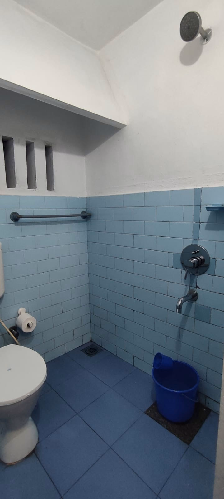 Clean bathroom with pale blue wall tiles