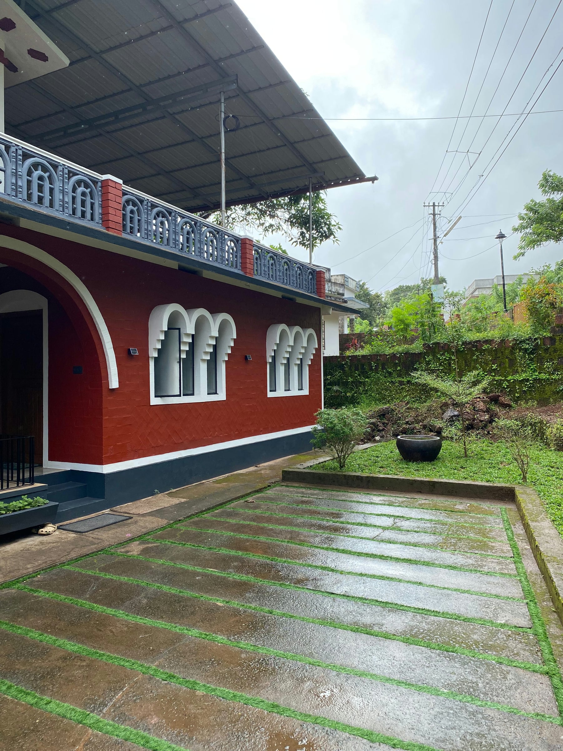 Garden walkway beside the red heritage home