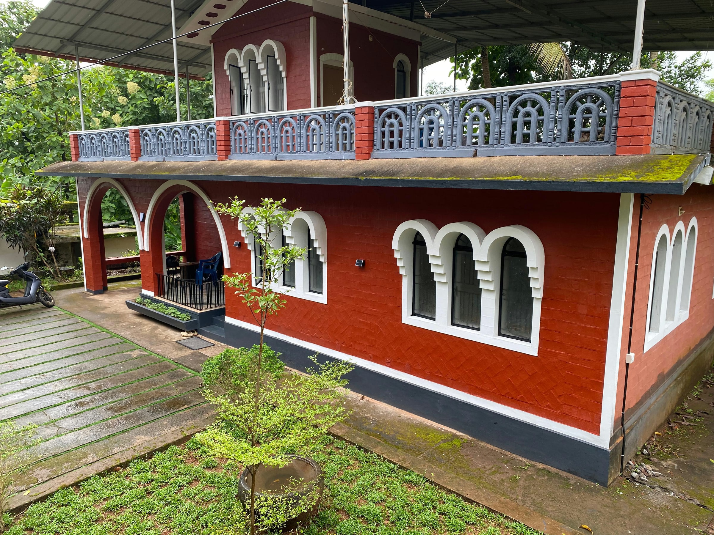 Side facade of Vysakham Heritage with garden paving